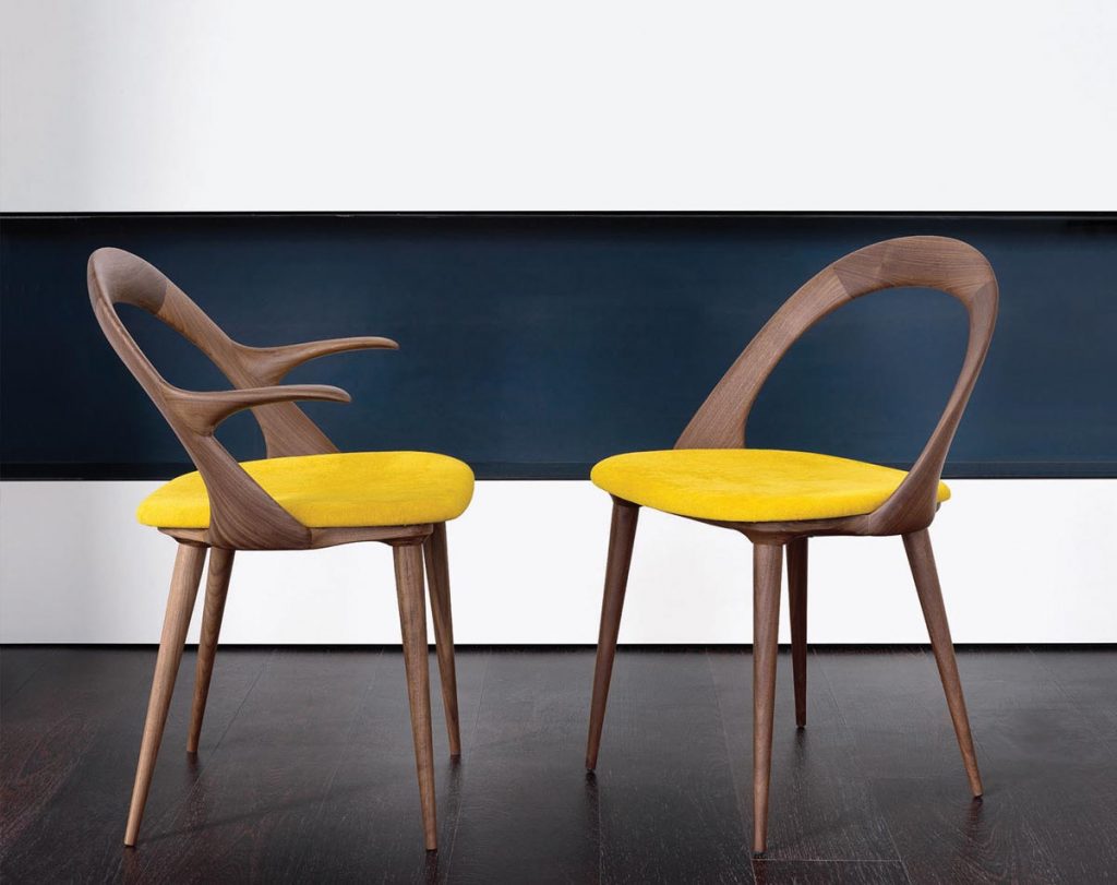 Yellow upholstery on the seat of the Ester chair by Anima Domus emboldens the sculptural silhouette of an already striking piece of furniture
